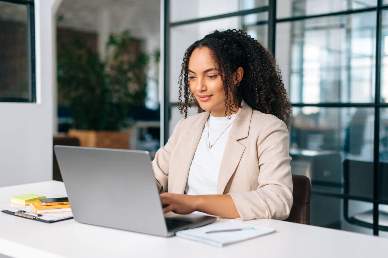 A woman sitting at a table with a laptop.