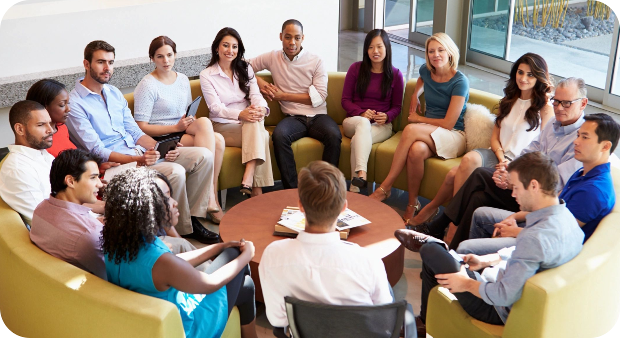 A group of people sitting around each other.